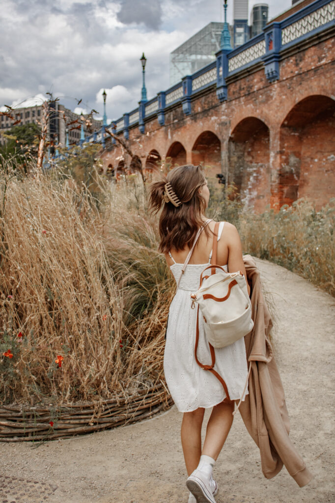 Girl walking in gardens on a cloudy day