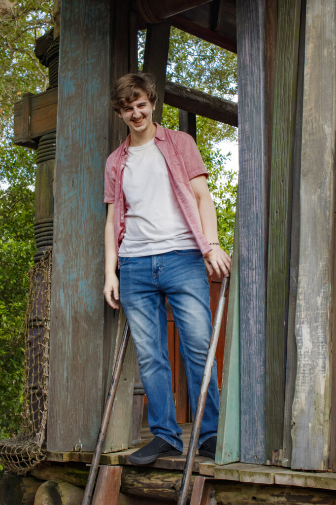 Boy standing in wood frame